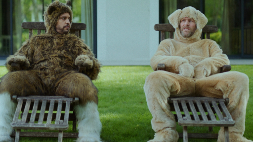 Two dogs sitting chatting on chaises longues