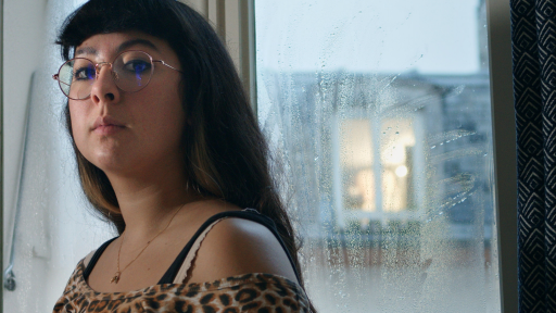 Young person in front of a window